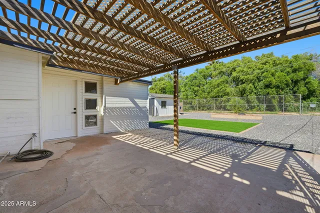 a view of a backyard with a wooden fence