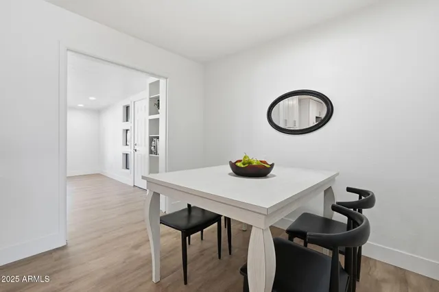 a view of a kitchen area with table and chairs