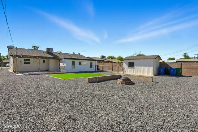 a swimming pool with outdoor seating and yard