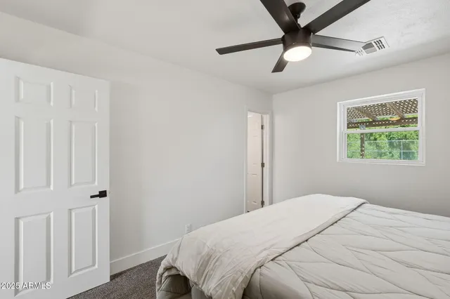 a bedroom with a bed and a window