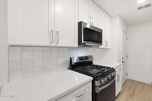 a kitchen with a stove and a microwave