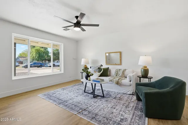 a living room with furniture and a wooden floor