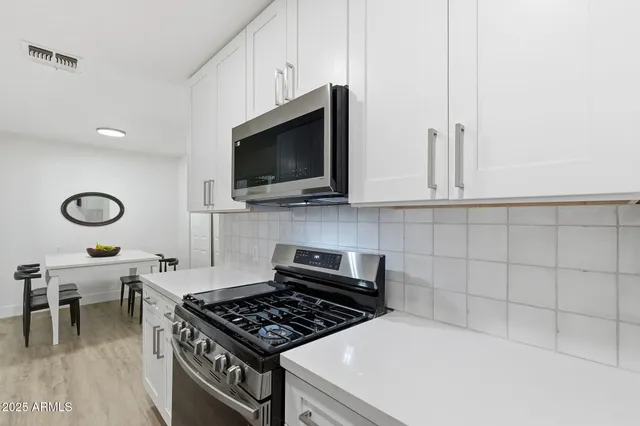 a front view of a house with a garden and yard