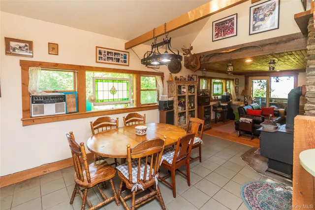 a view of a dining room with furniture a chandelier and wooden floor
