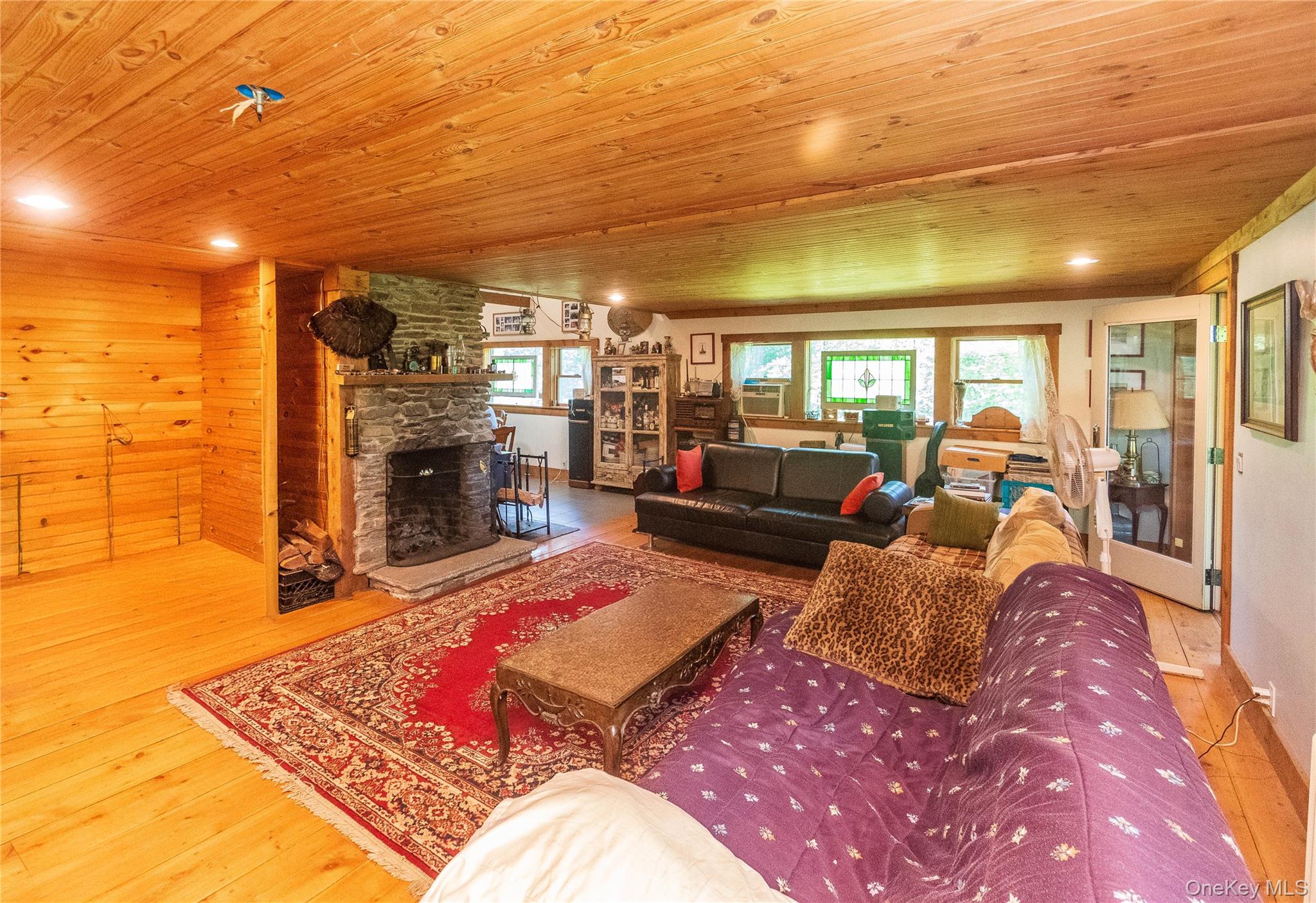 885 Grandview Road Hancock, NY 13783 - Photo 40 of 45 a living room with furniture a fireplace and a flat screen tv