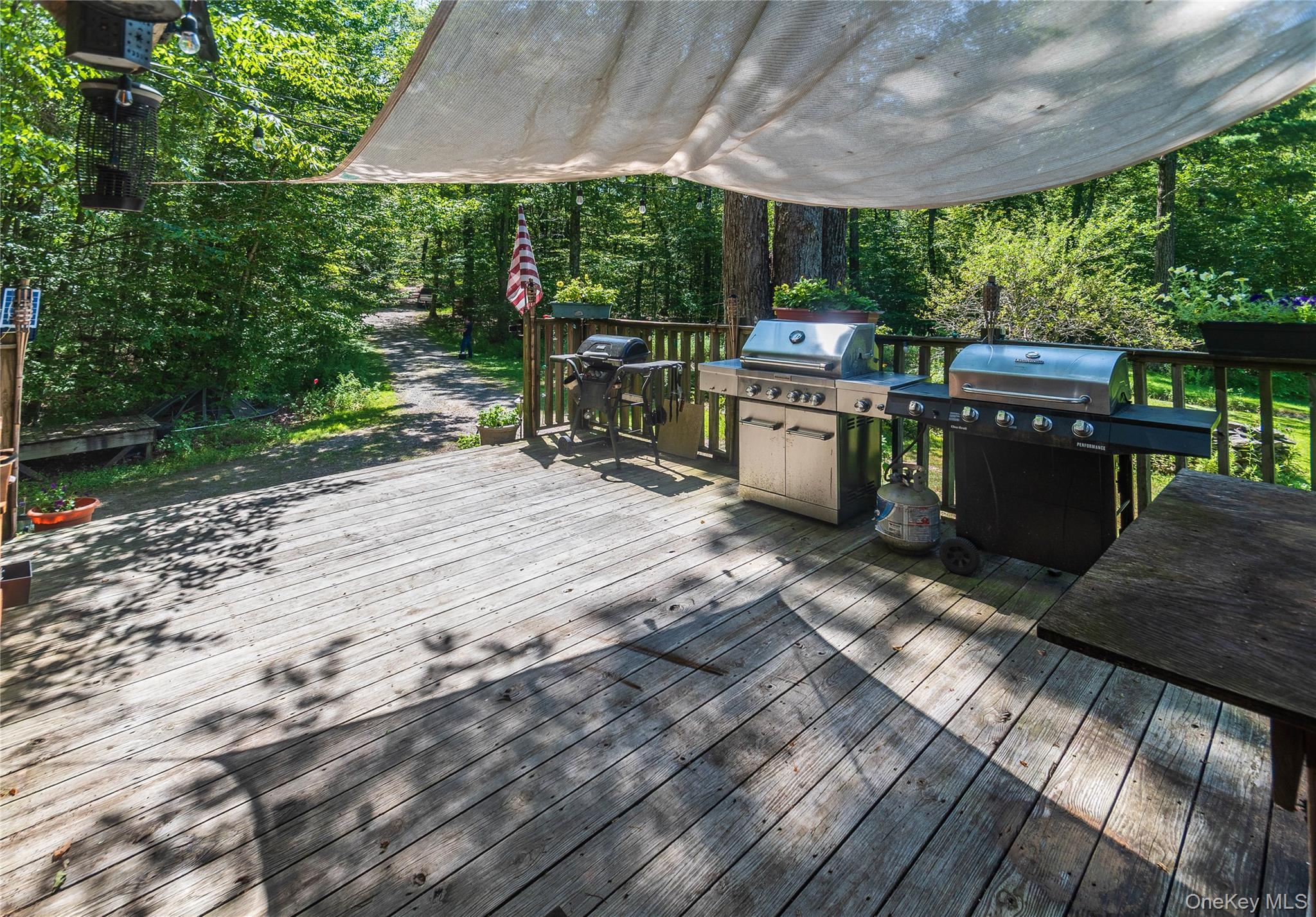 885 Grandview Road Hancock, NY 13783 - Photo 42 of 45 a view of a patio with table and chairs barbeque grill with wooden fence