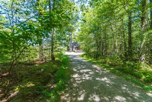 a backyard of a house with lots of green space and fountain
