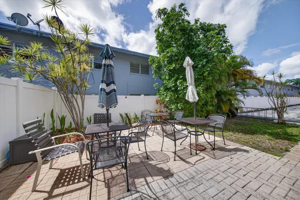 a view of patio with table and chairs and potted plants