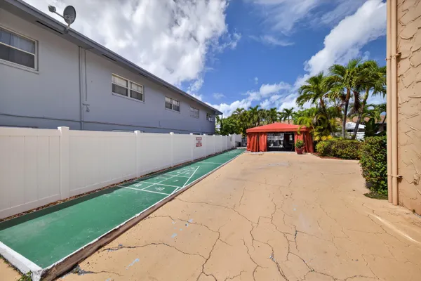 a swimming pool with yard in front of it