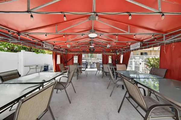 a view of a patio with table and chairs and potted plants