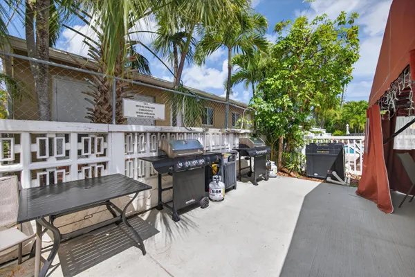 a view of a patio with a table and chairs