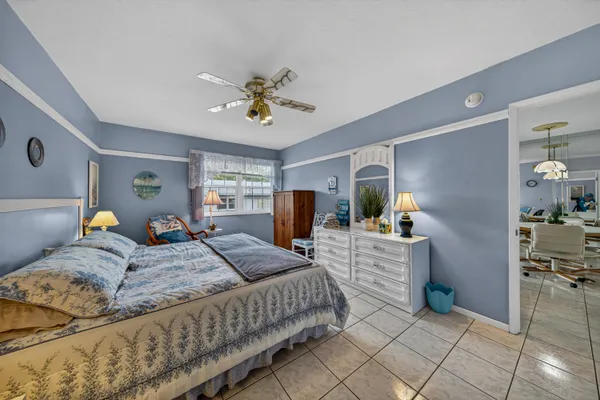 a bedroom with a bed a chandelier and closet