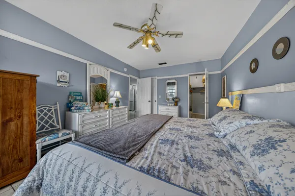 a bed room with a bed mirror and a flat tv screen