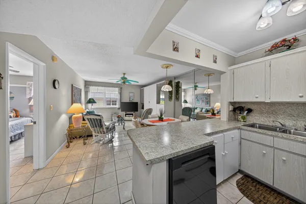 a kitchen with a sink a stove cabinets and counter space