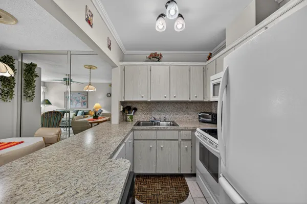 a kitchen with a sink stove and cabinets