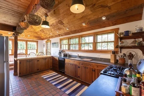 a kitchen with lots of counter top space and wooden floor