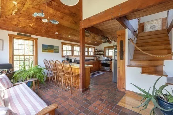 a view of a porch with chairs and potted plants