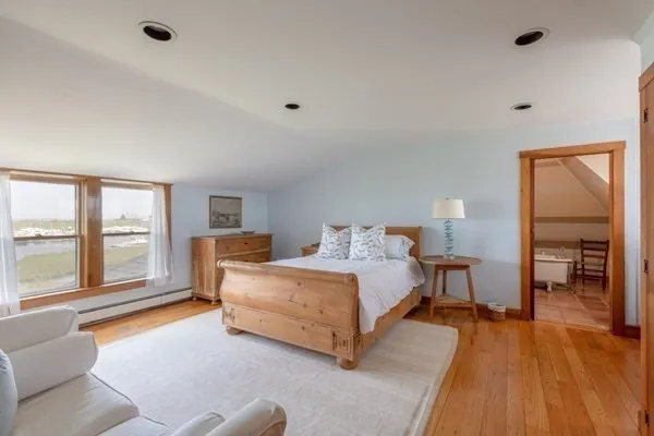 a spacious bedroom with a bed and a large window