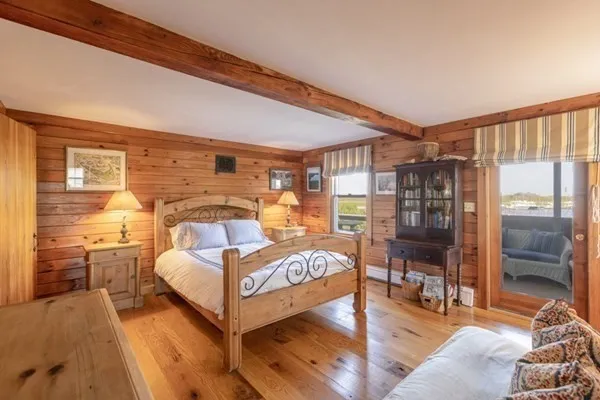 a bedroom with furniture and a large window