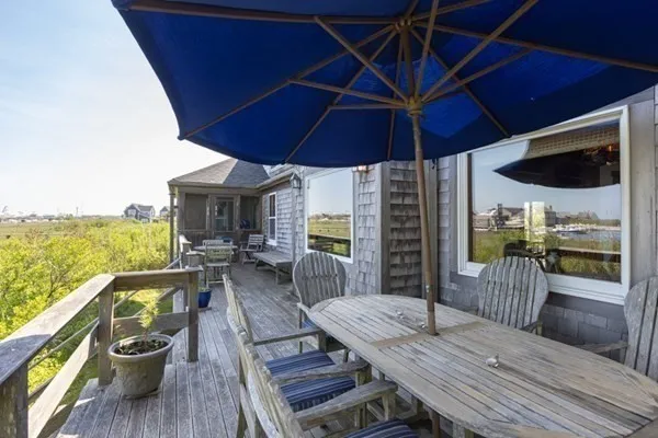 a view of a patio with table and chairs under an umbrella
