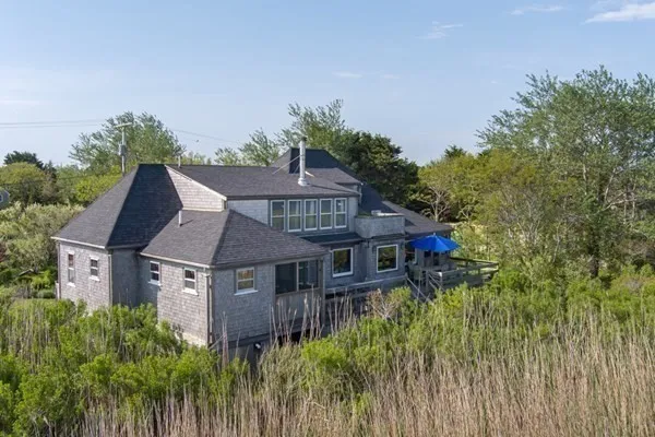 an aerial view of a house with a yard