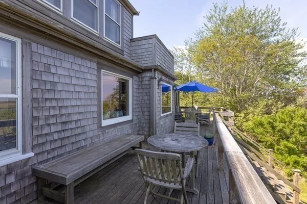 a balcony with table and chairs
