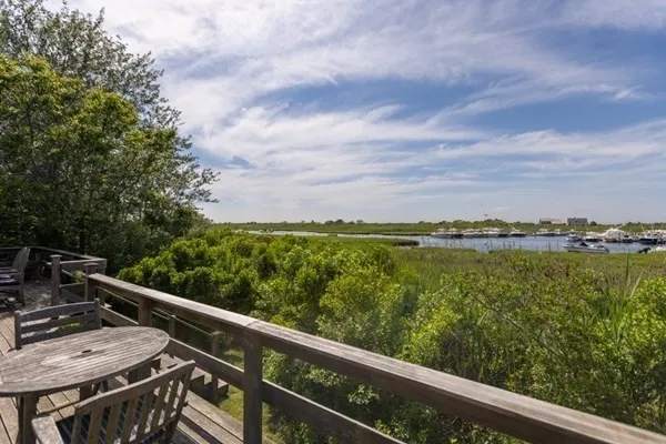 a view of a balcony with lake view and wooden floor
