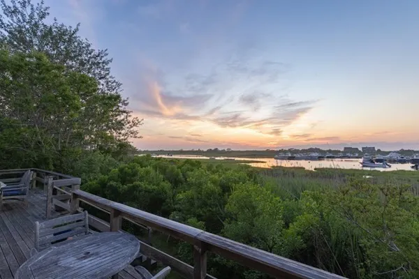 a view of a balcony with mountain view and trees