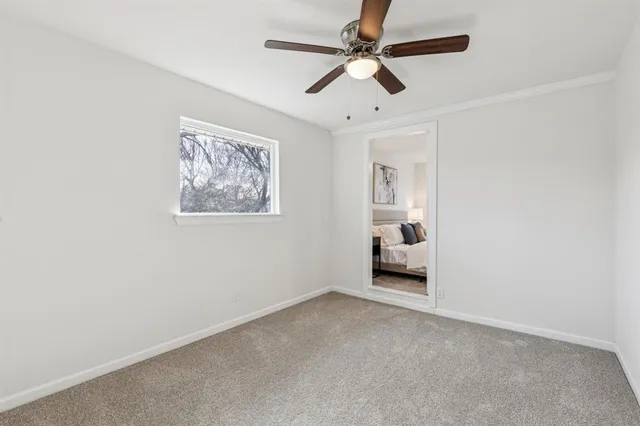 a view of room with a ceiling fan and window