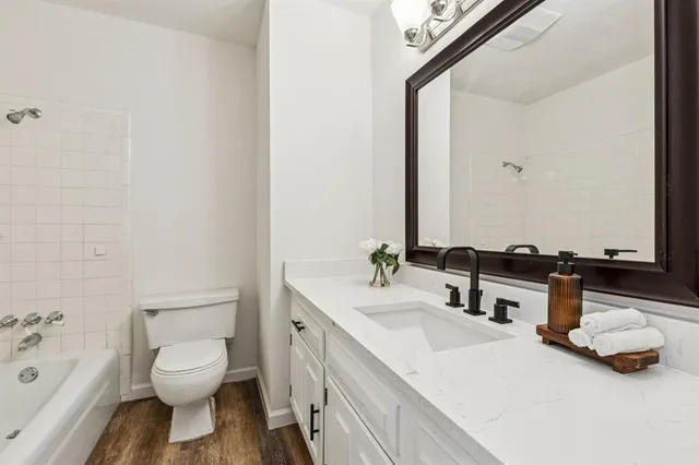 a bathroom with a sink toilet and a mirror