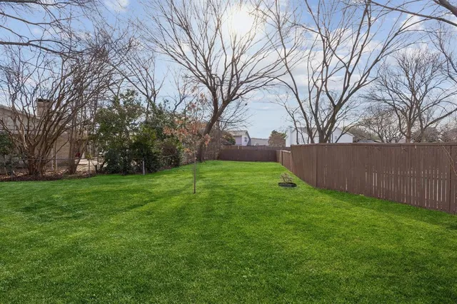 a view of a backyard with large trees