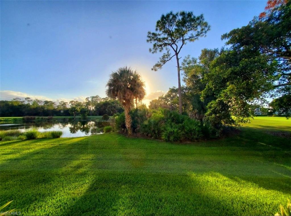 925 Eastham Way, Unit J102 Naples, FL 34104 - Photo 3 of 13 a view of a lake with a yard