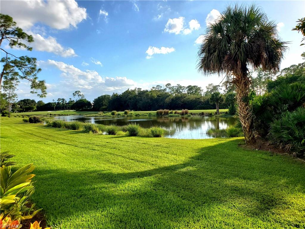 925 Eastham Way, Unit J102 Naples, FL 34104 - Photo 6 of 13 a view of a golf course with a lake