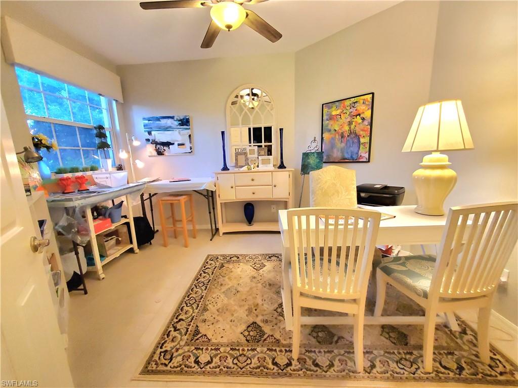 925 Eastham Way, Unit J102 Naples, FL 34104 - Photo 7 of 13 a living room with a couch and a chandelier