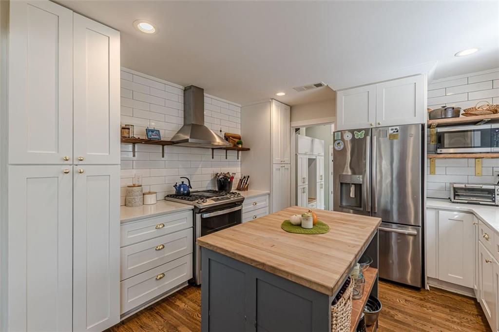 3424 Old Jonesboro Road Atlanta, GA 30354 - Photo 22 of 75 a kitchen with refrigerator cabinets and wooden floor