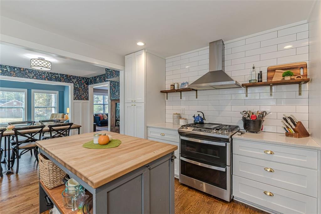 3424 Old Jonesboro Road Atlanta, GA 30354 - Photo 23 of 75 a kitchen with a stove a sink and a wooden cabinets