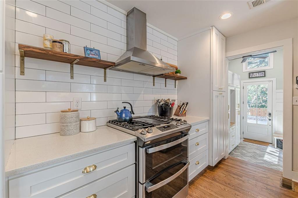 3424 Old Jonesboro Road Atlanta, GA 30354 - Photo 25 of 75 a kitchen with stainless steel appliances a stove and cabinets