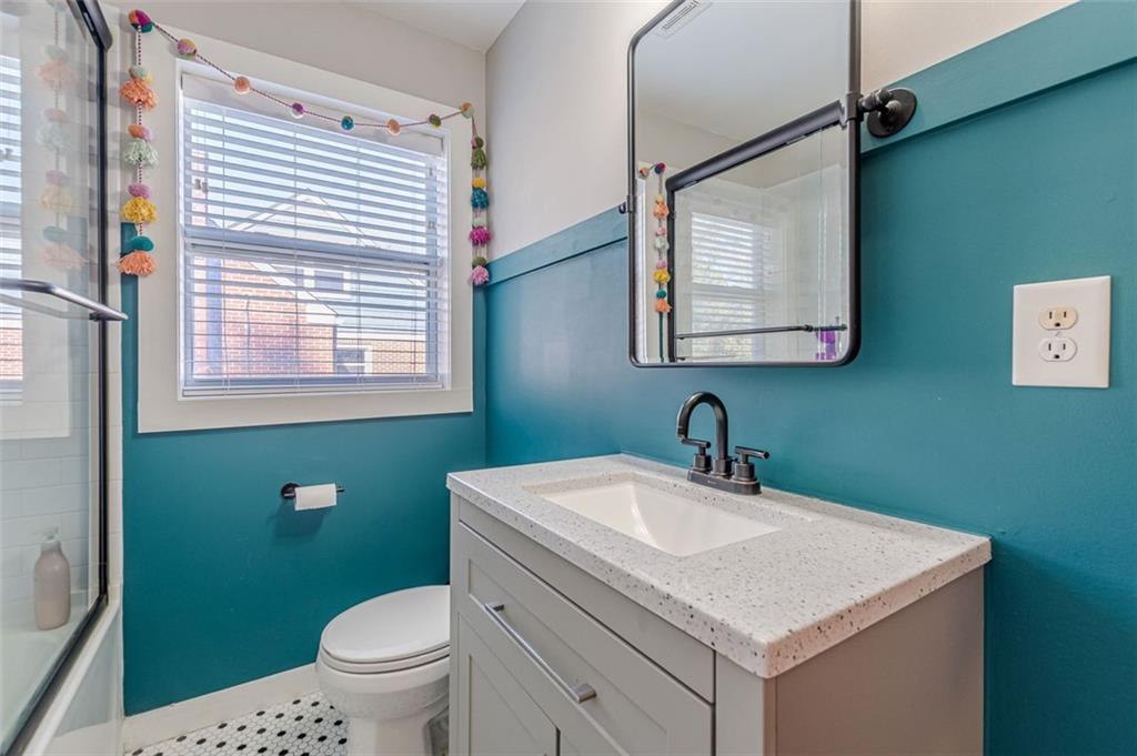 3424 Old Jonesboro Road Atlanta, GA 30354 - Photo 35 of 75 a bathroom with a sink a toilet and a mirror