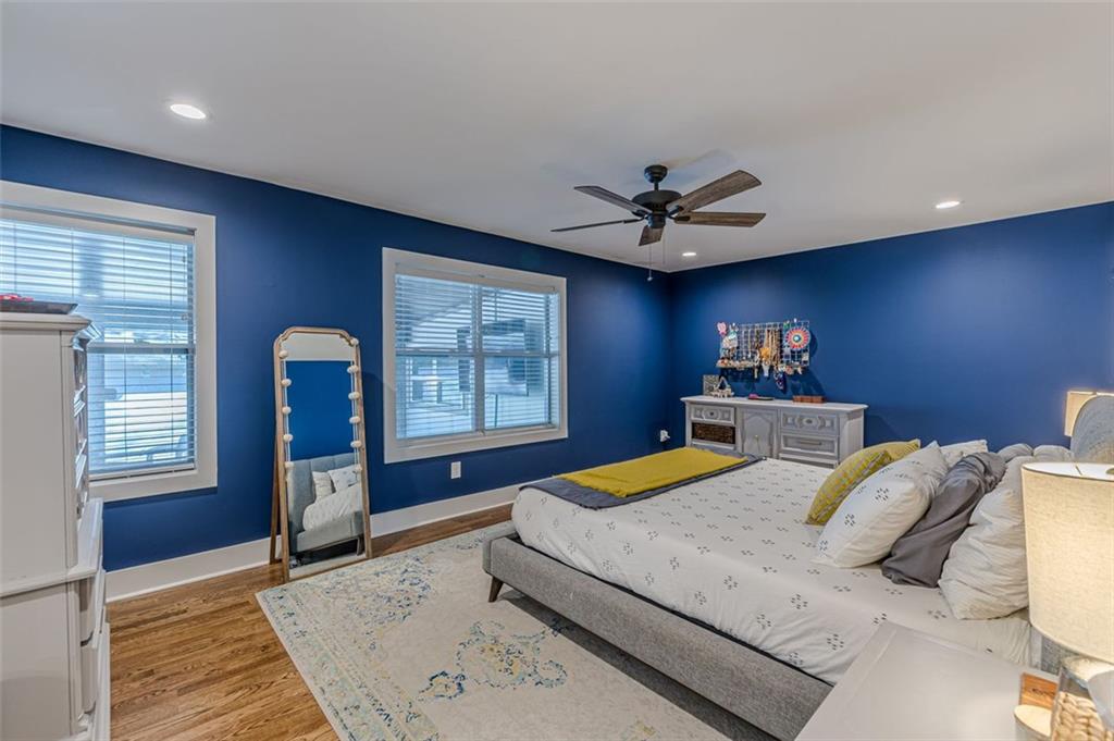 3424 Old Jonesboro Road Atlanta, GA 30354 - Photo 37 of 75 a bedroom with a large bed and a chandelier