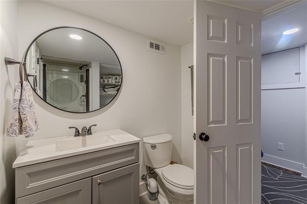 3424 Old Jonesboro Road Atlanta, GA 30354 - Photo 54 of 75 a bathroom with a toilet a sink and mirror