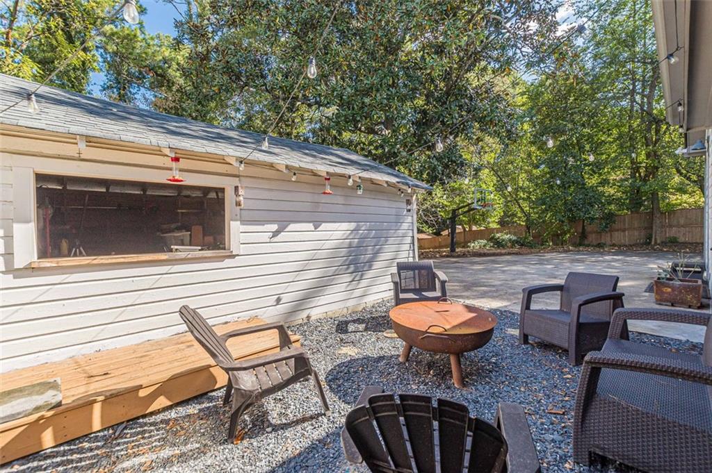 3424 Old Jonesboro Road Atlanta, GA 30354 - Photo 7 of 75 a backyard of a house with barbeque oven table and chairs