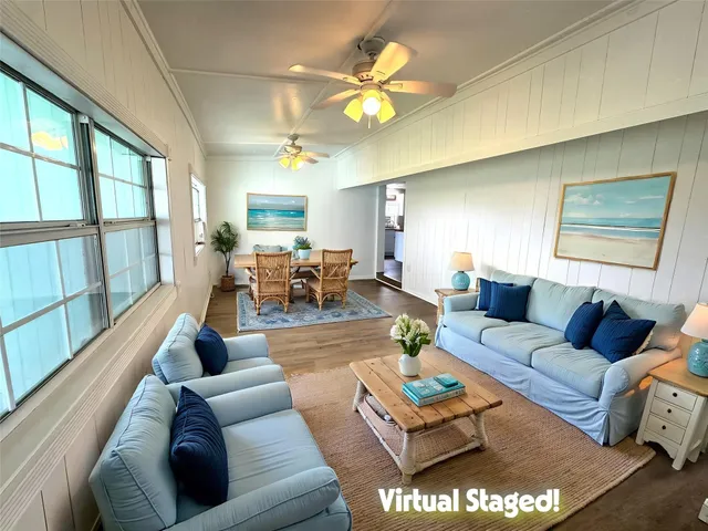 a living room with furniture a chandelier and a table