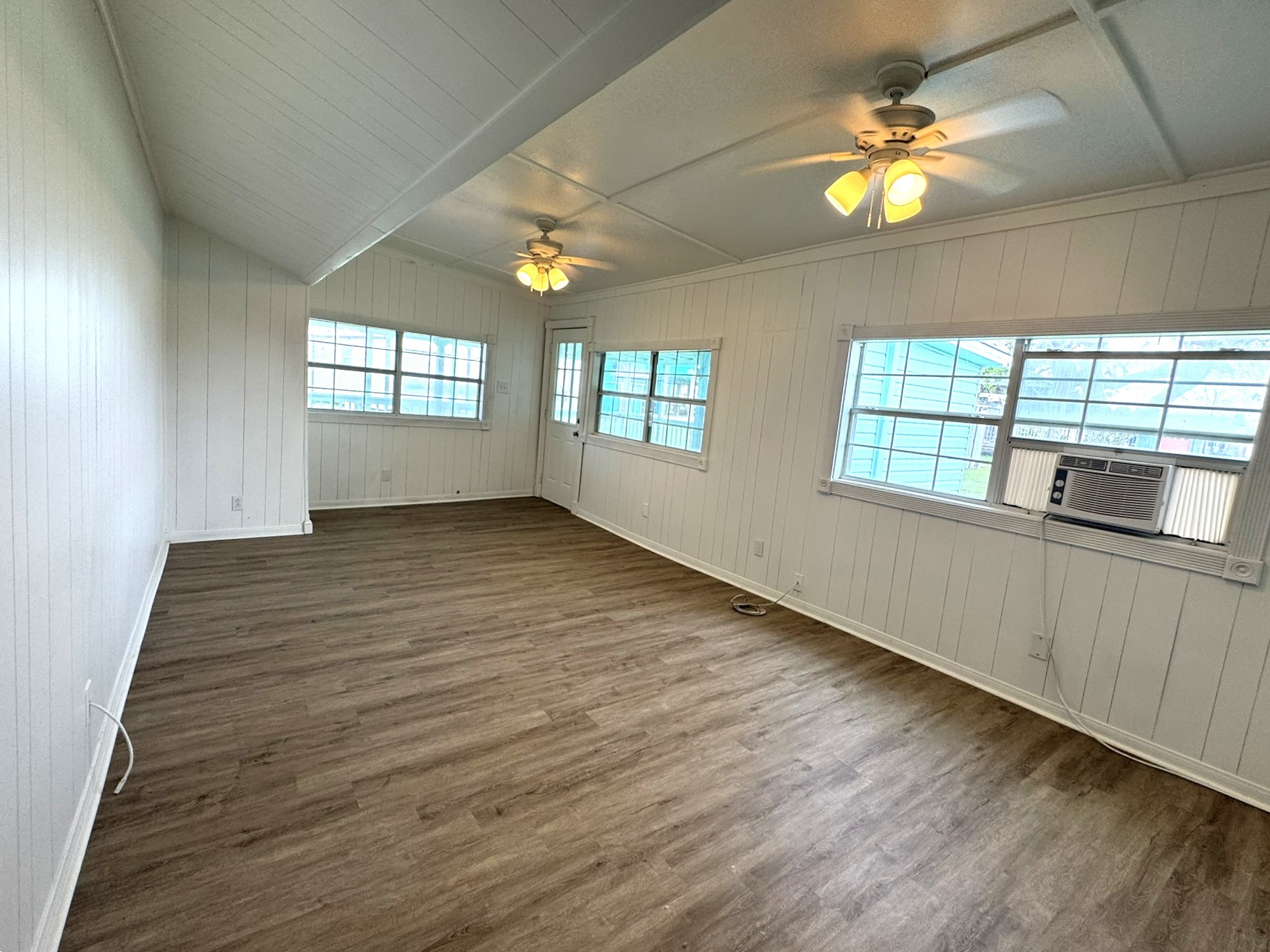302 2nd Street Palacios, TX 77465 - Photo 13 of 45 wooden floor in an empty room with a window