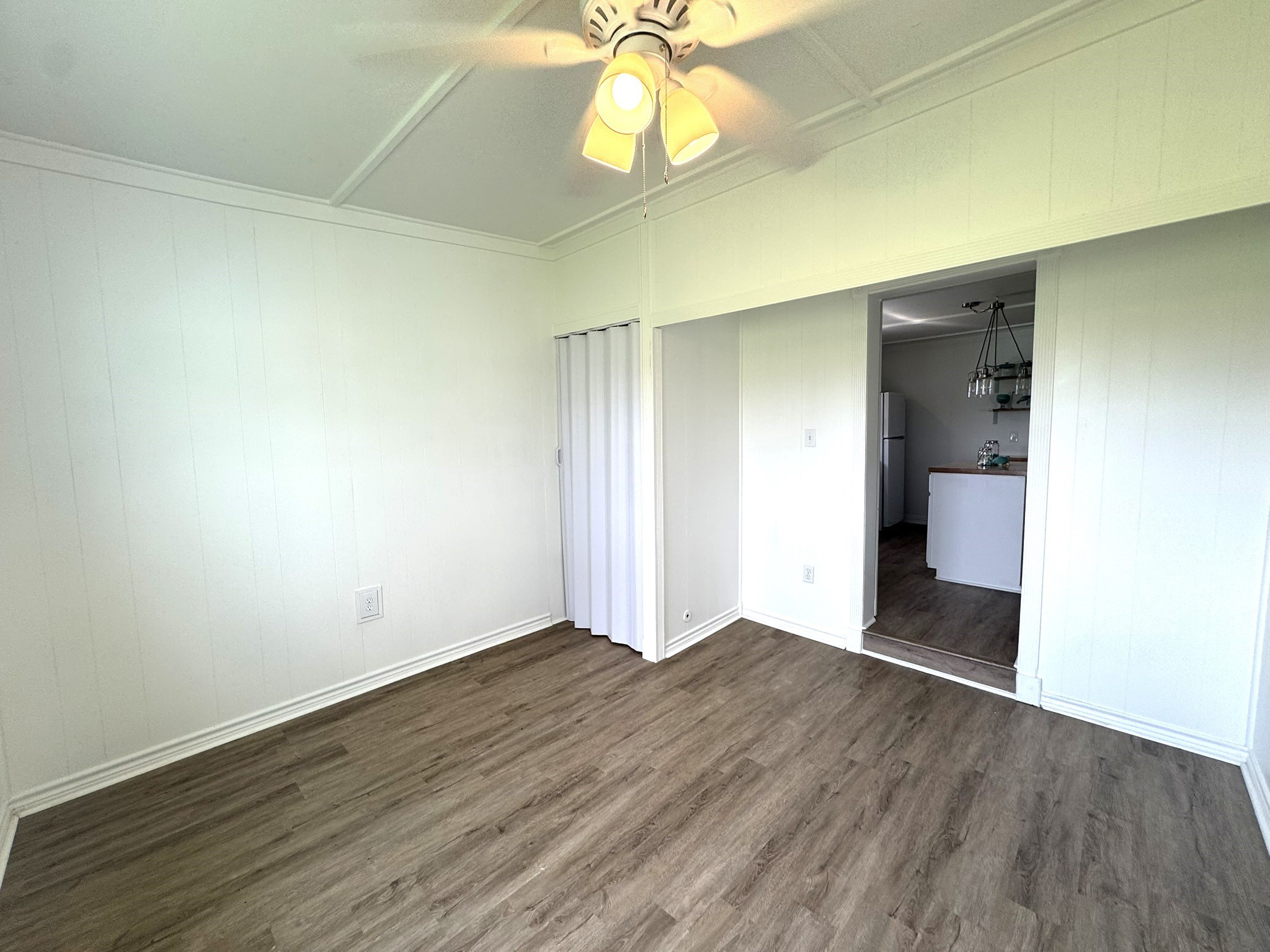 302 2nd Street Palacios, TX 77465 - Photo 16 of 45 an empty room with wooden floor and windows