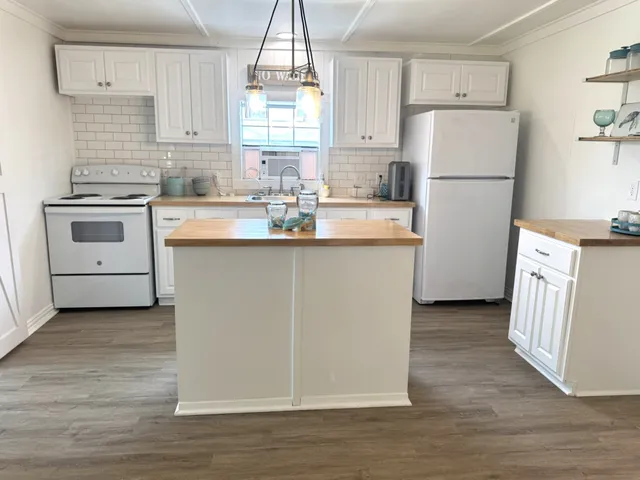 a kitchen with white cabinets and white appliances
