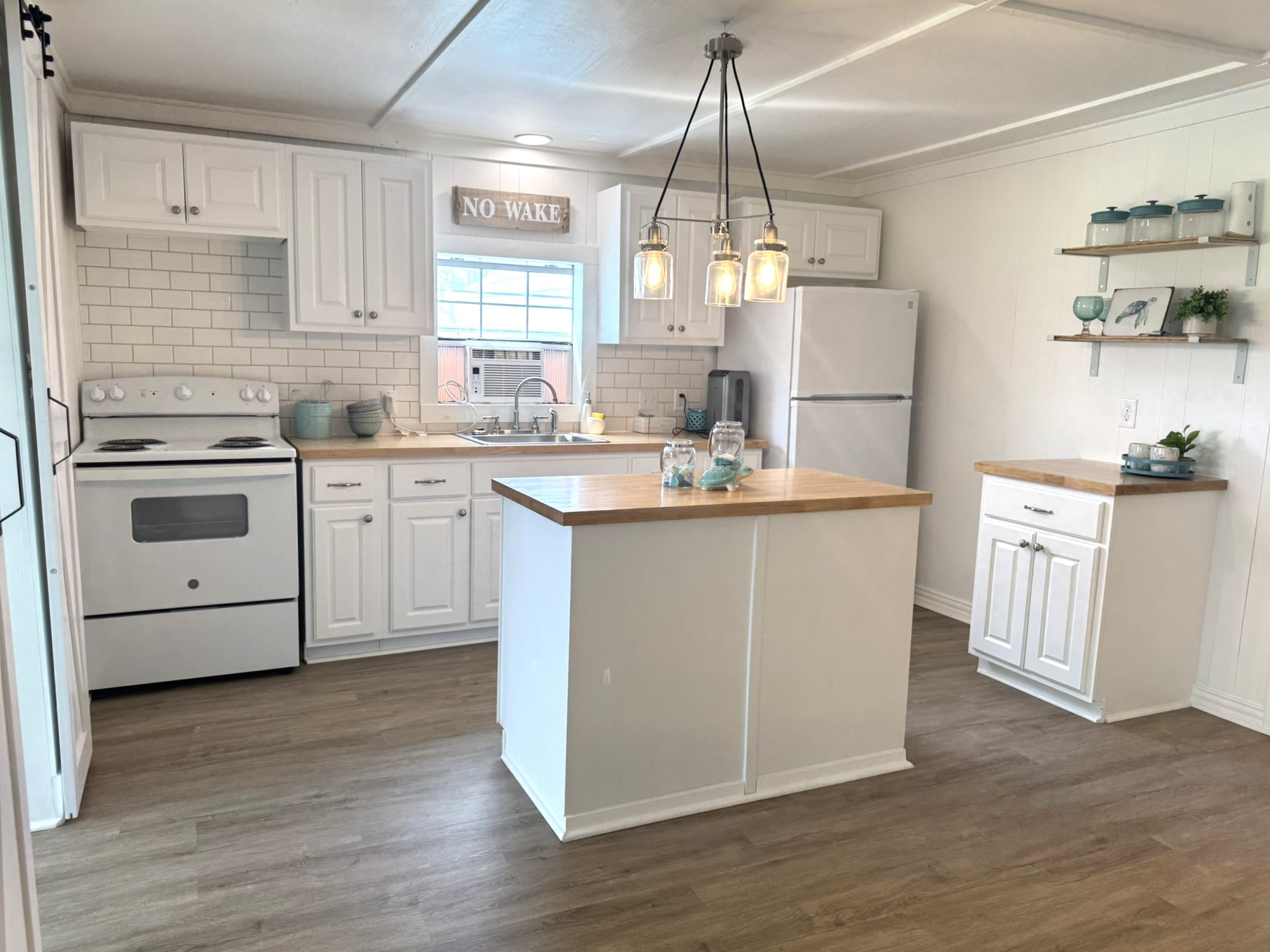 302 2nd Street Palacios, TX 77465 - Photo 2 of 45 a kitchen with cabinets a sink and appliances