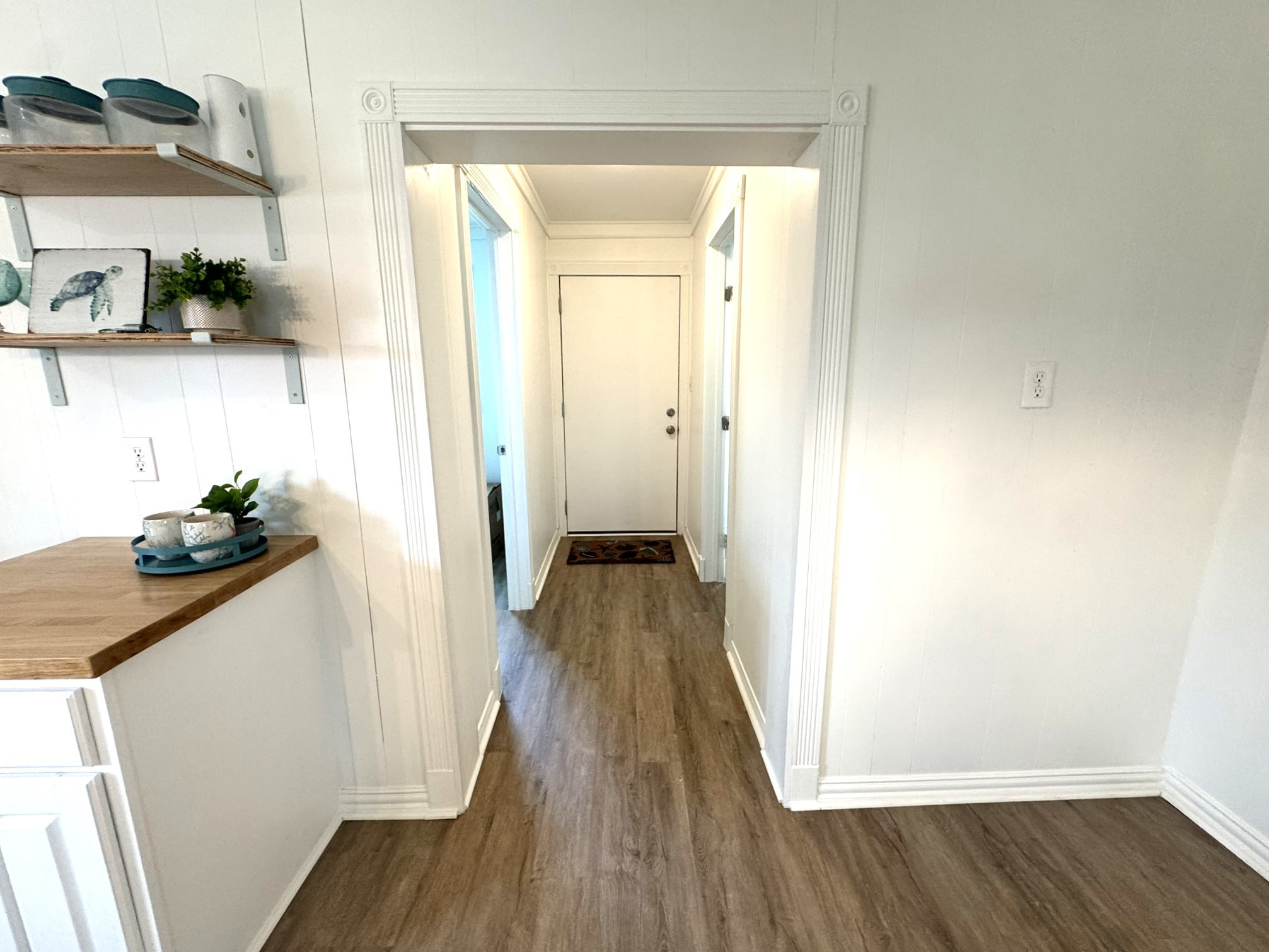 302 2nd Street Palacios, TX 77465 - Photo 28 of 45 a view of a hallway with wooden floor and staircase