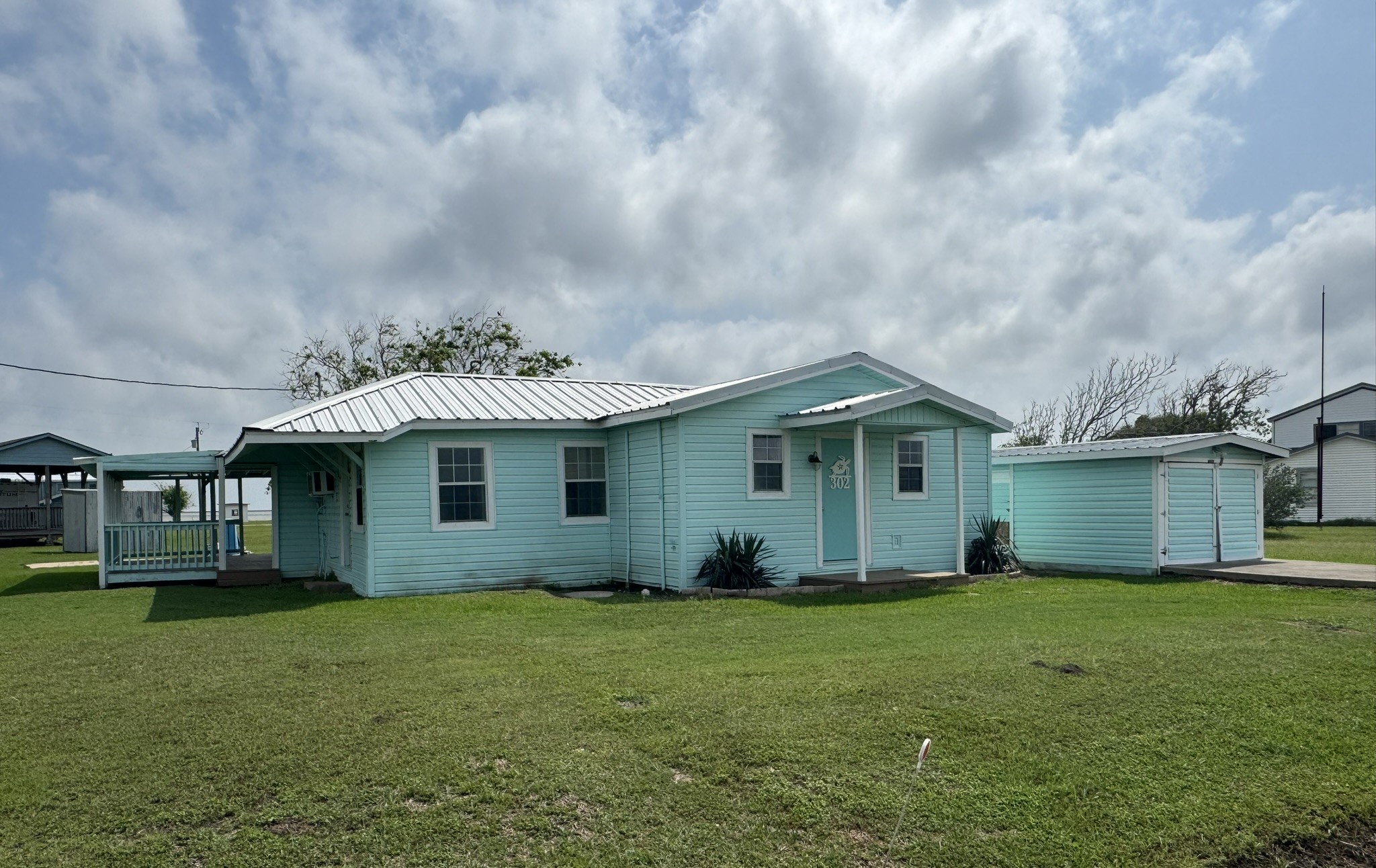 302 2nd Street Palacios, TX 77465 - Photo 4 of 45 a front view of house with yard and green space