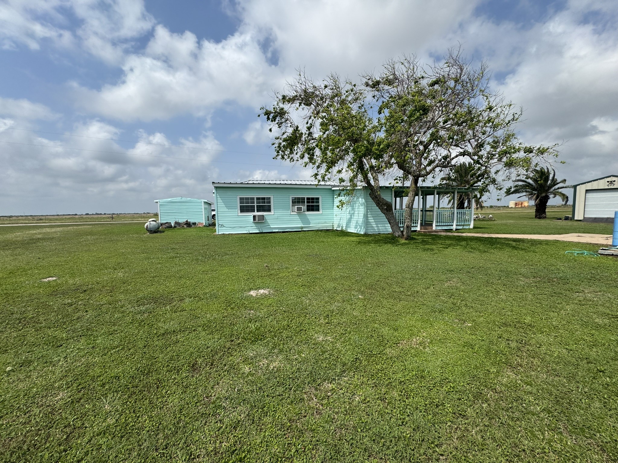 302 2nd Street Palacios, TX 77465 - Photo 41 of 45 a view of a house with a big yard and large trees