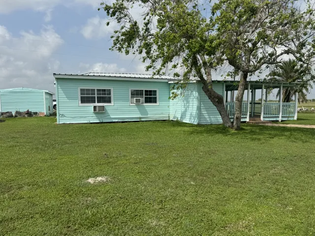 a front view of house with yard and trees